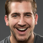 Smiling young man (real people) on gray background